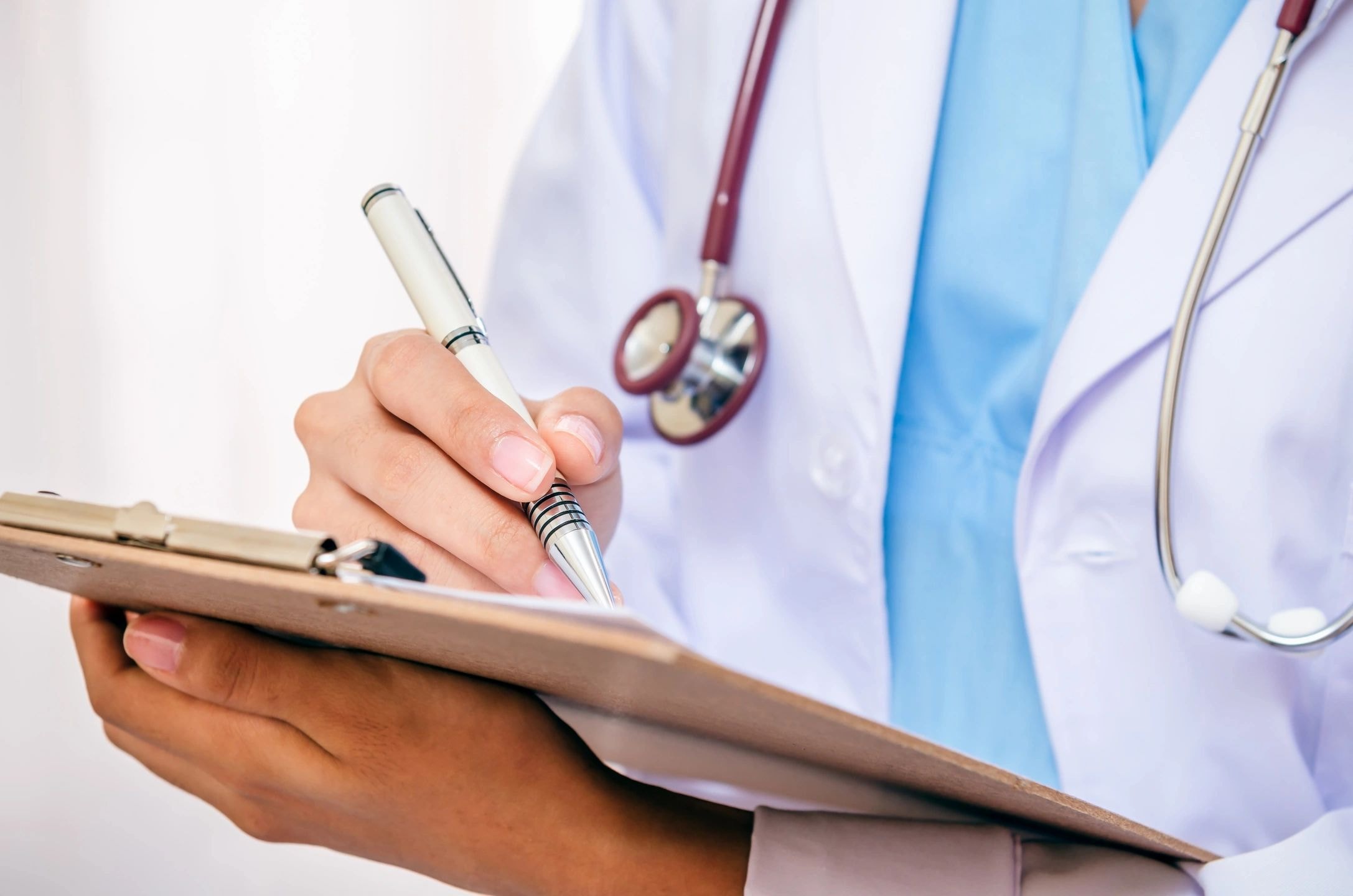 Physician reviewing patient notes at a clinic desk